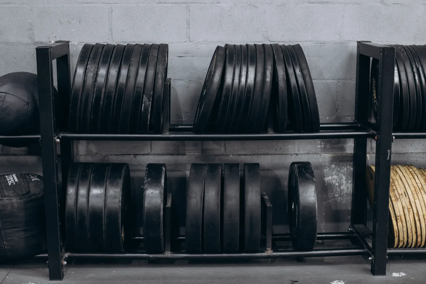 Weight plates arranged on a gym storage rack