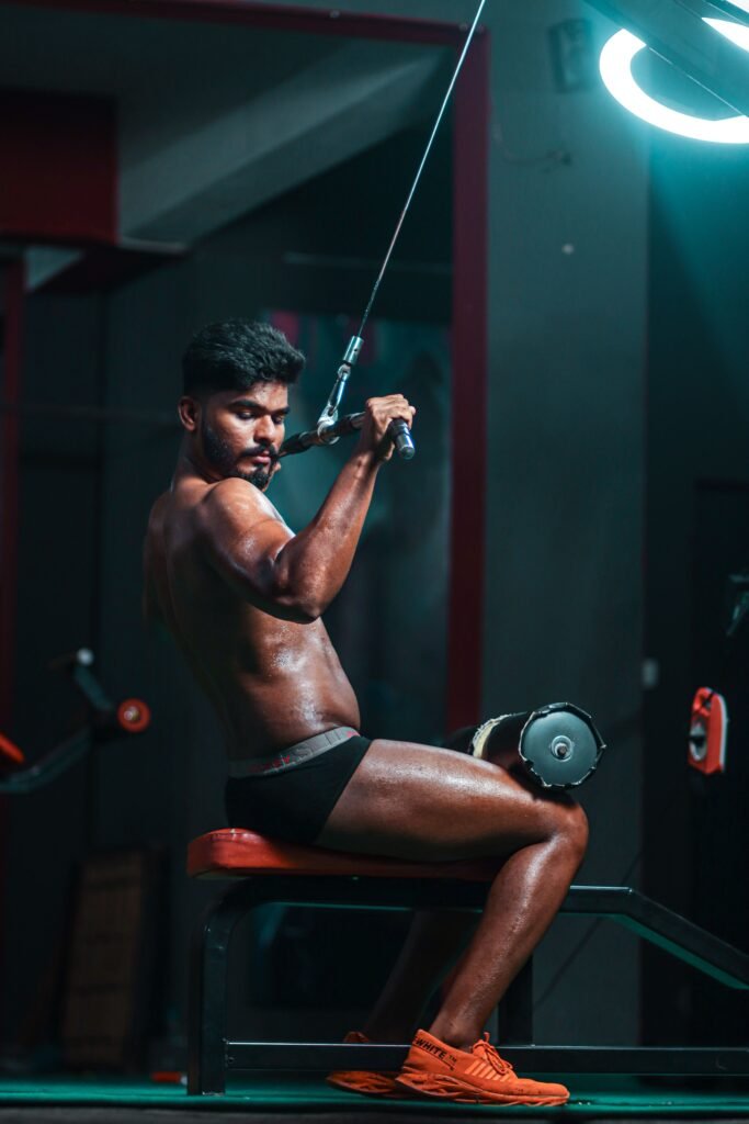 Man exercising with a cable machine in a gym