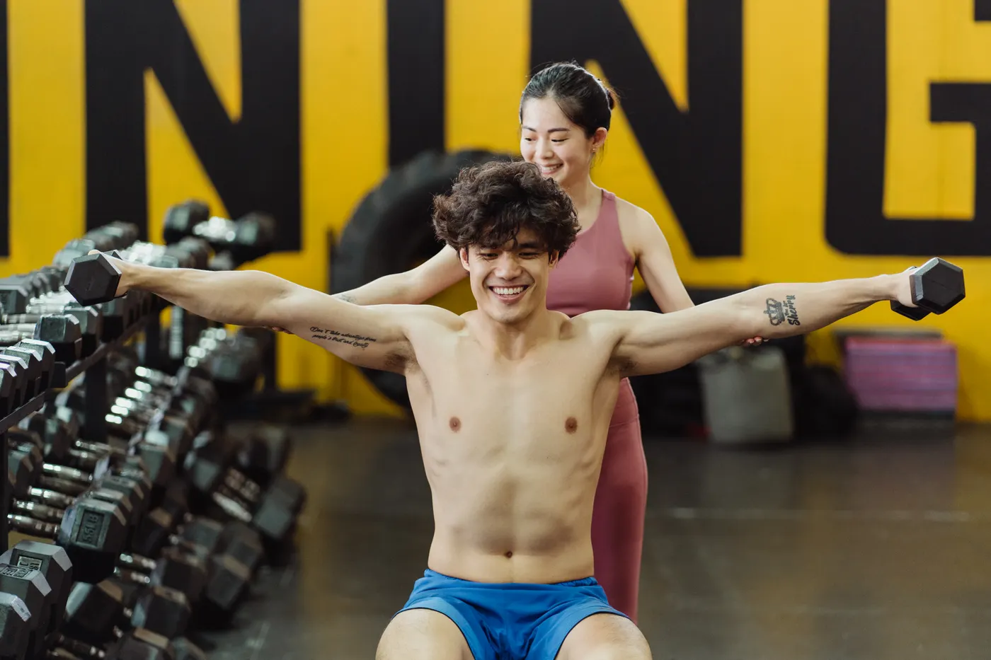 Two lifters training with dumbbells