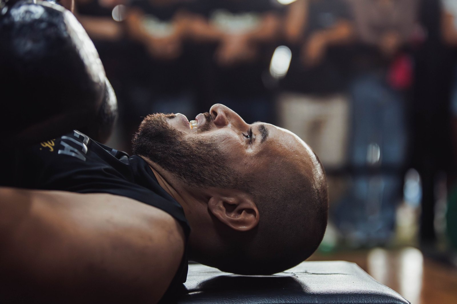 Athlete resting on a gym bench