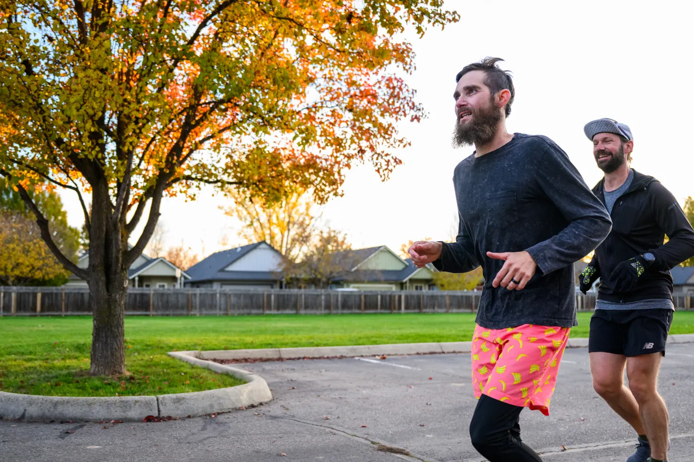 Two runners jogging outdoors on a park path