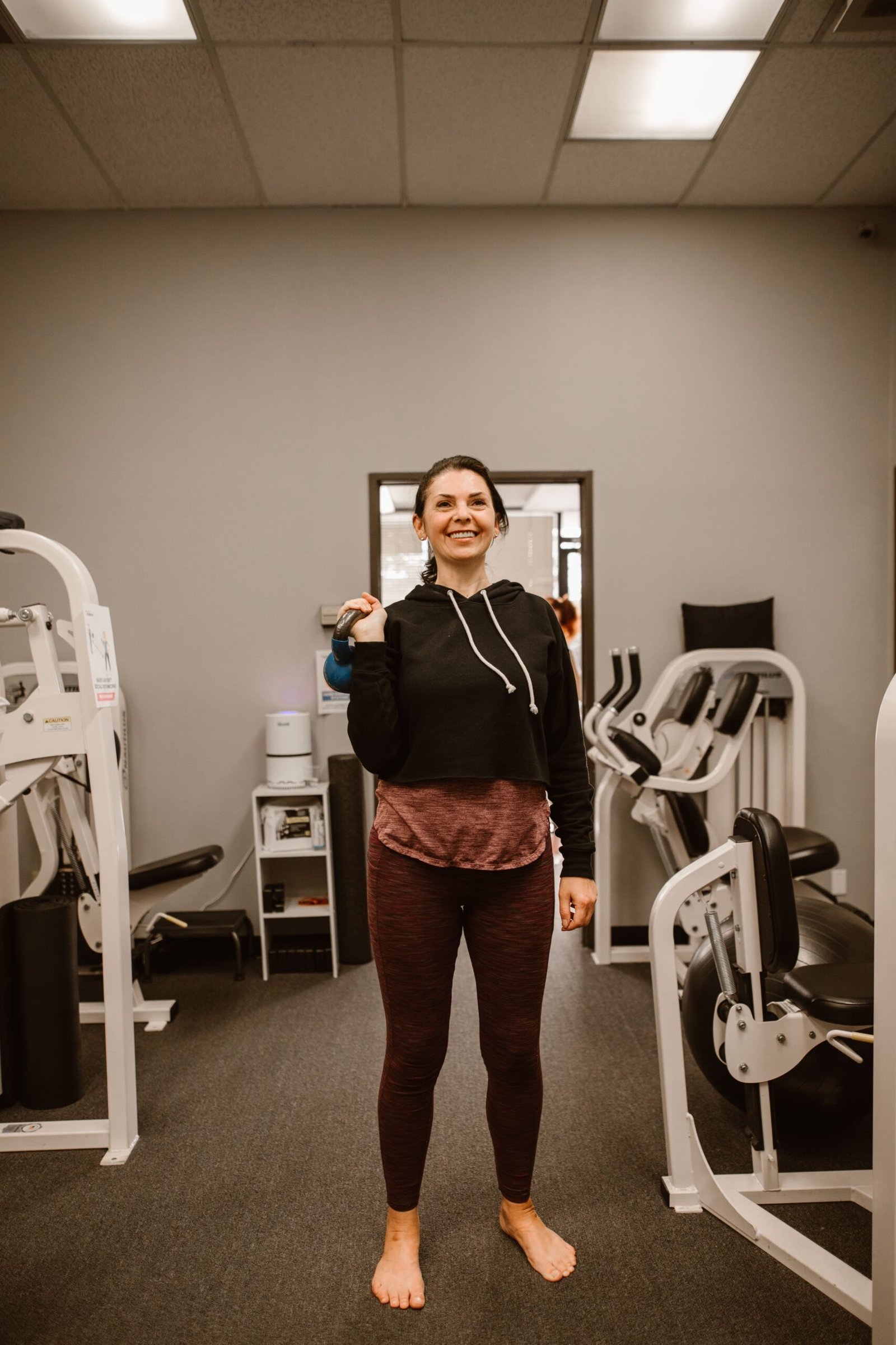 Woman holding a kettlebell at shoulder height