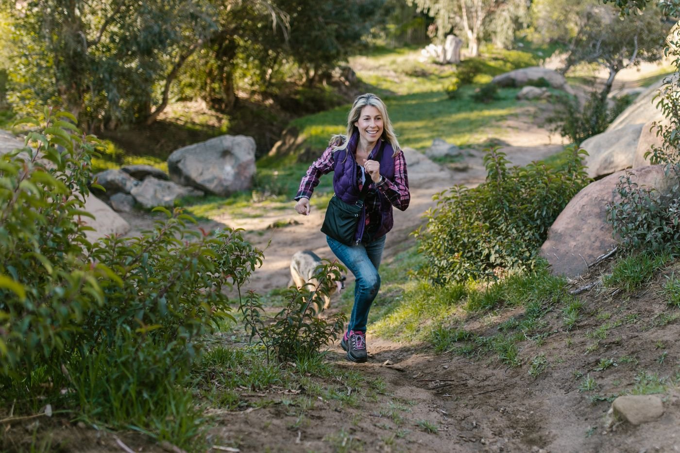 Woman jogging on a green park path