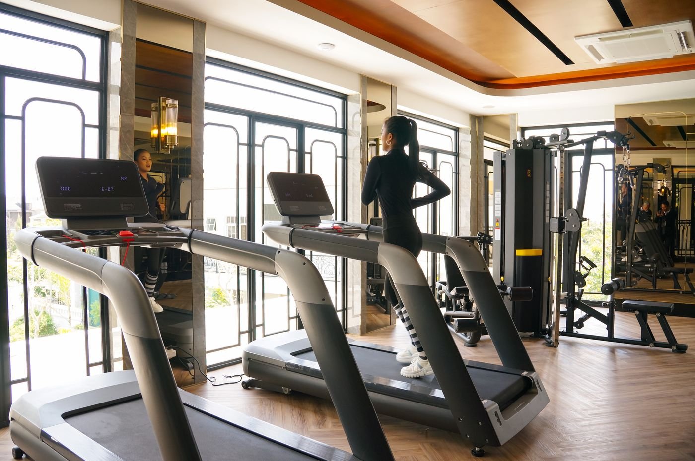 Woman training on a treadmill in a bright modern gym