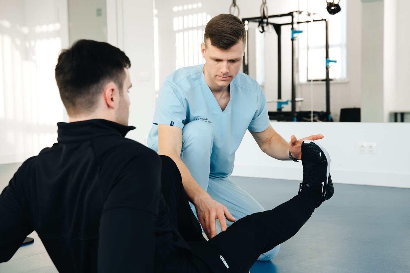 Physiotherapist assisting a patient with leg movement
