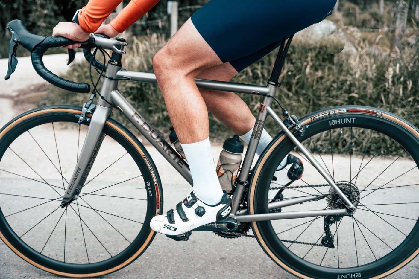 Close view of a cyclist's legs pedaling a road bike