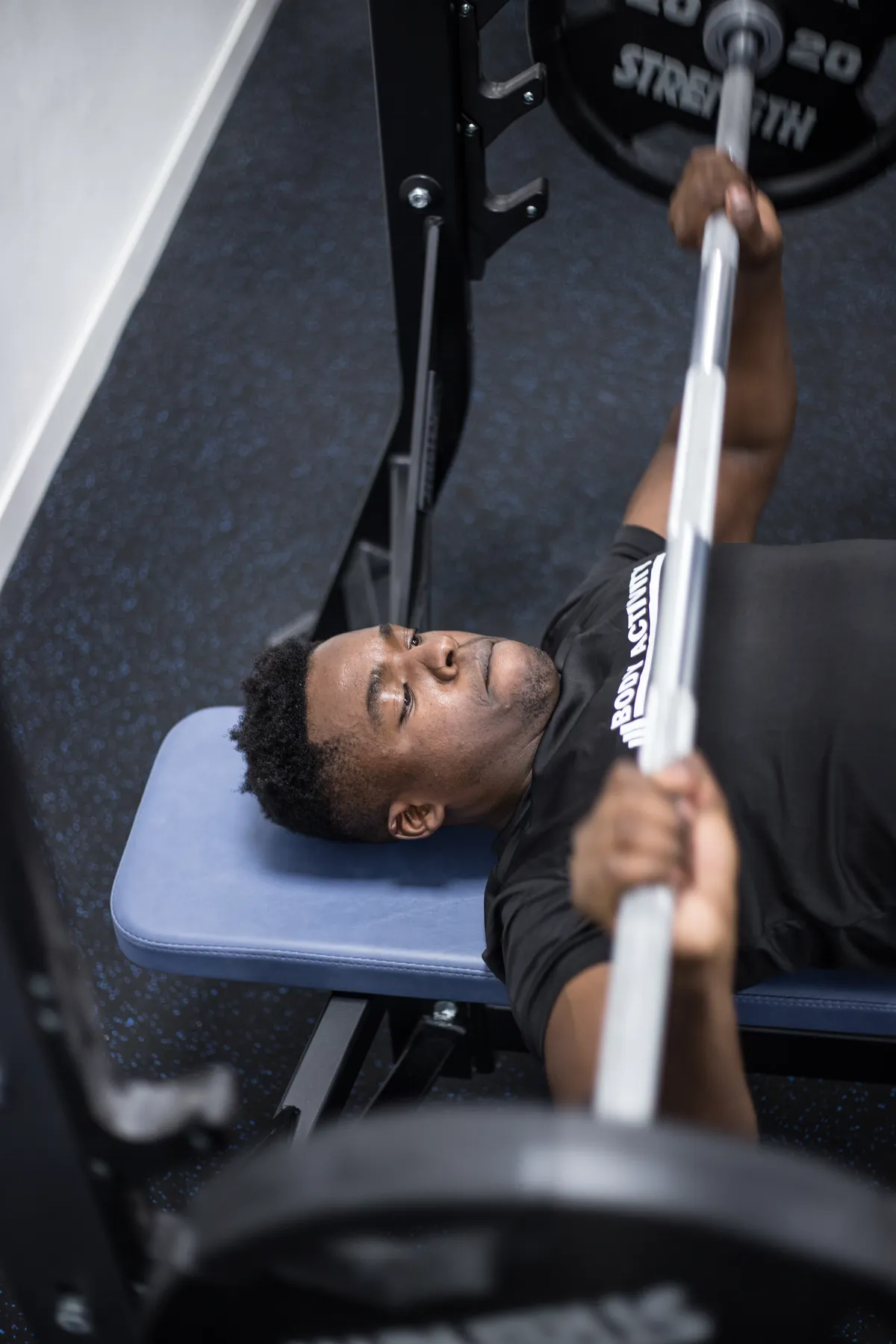 Man training the barbell bench press for upper-body strength