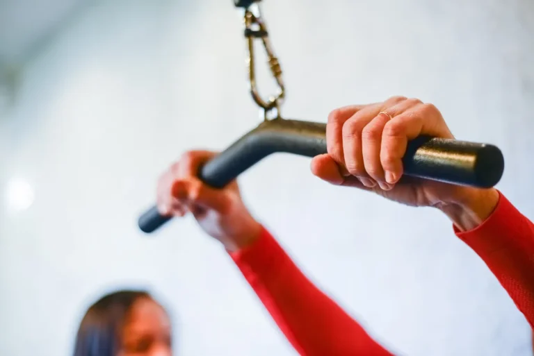 Close-up of hands holding a gym bar during strength training