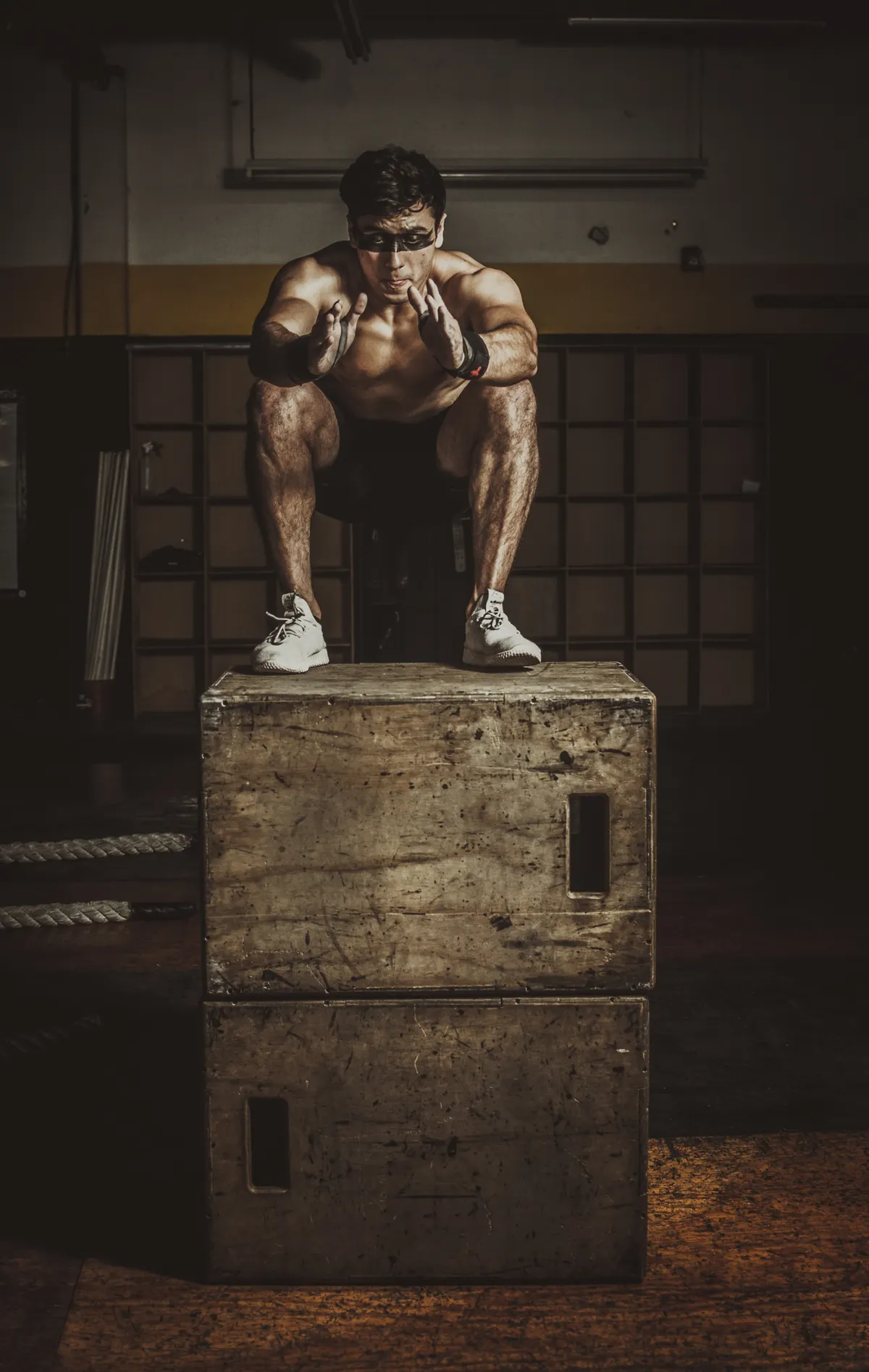 Athlete controlling a deep landing position on a plyometric box