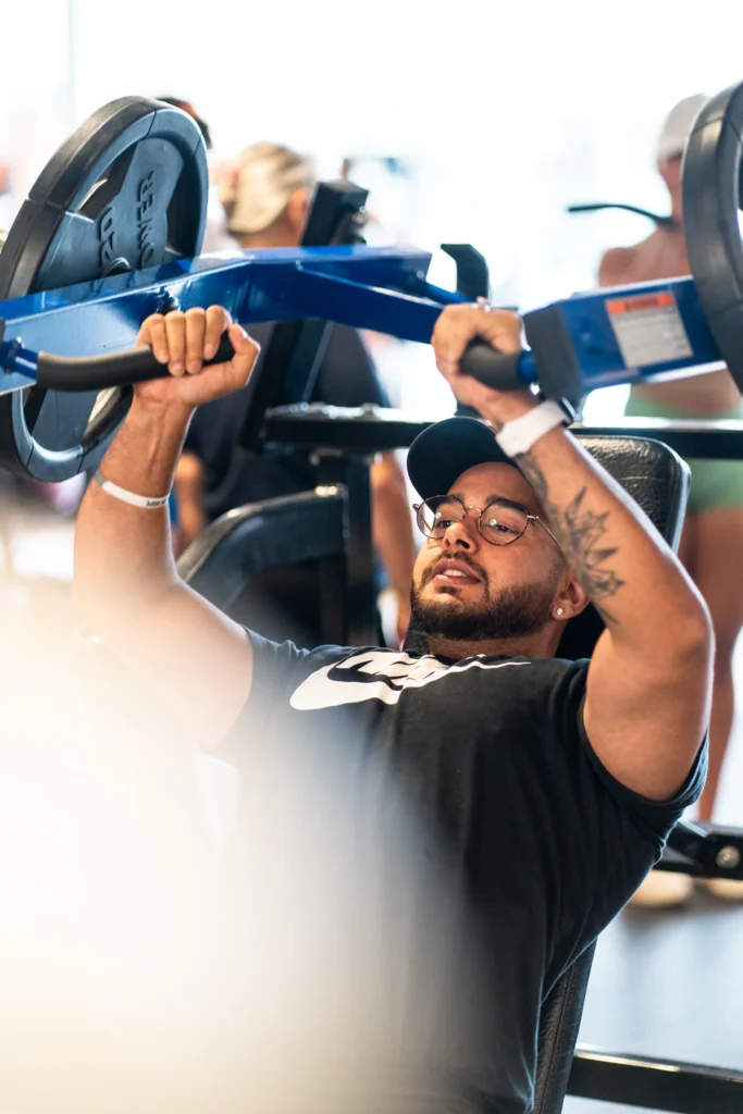 Athlete performing a barbell bench press on a flat bench