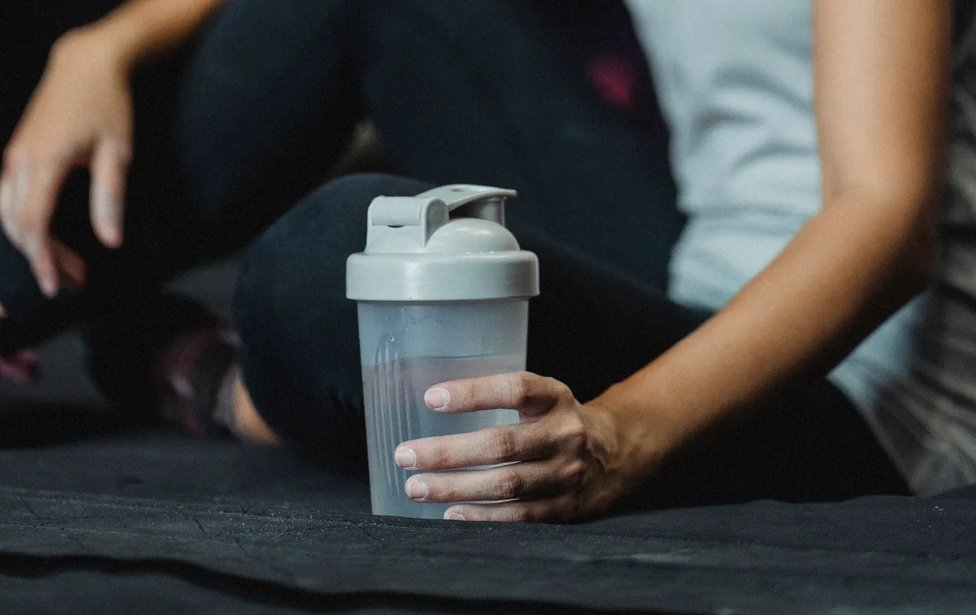 Woman resting after exercise with a water bottle