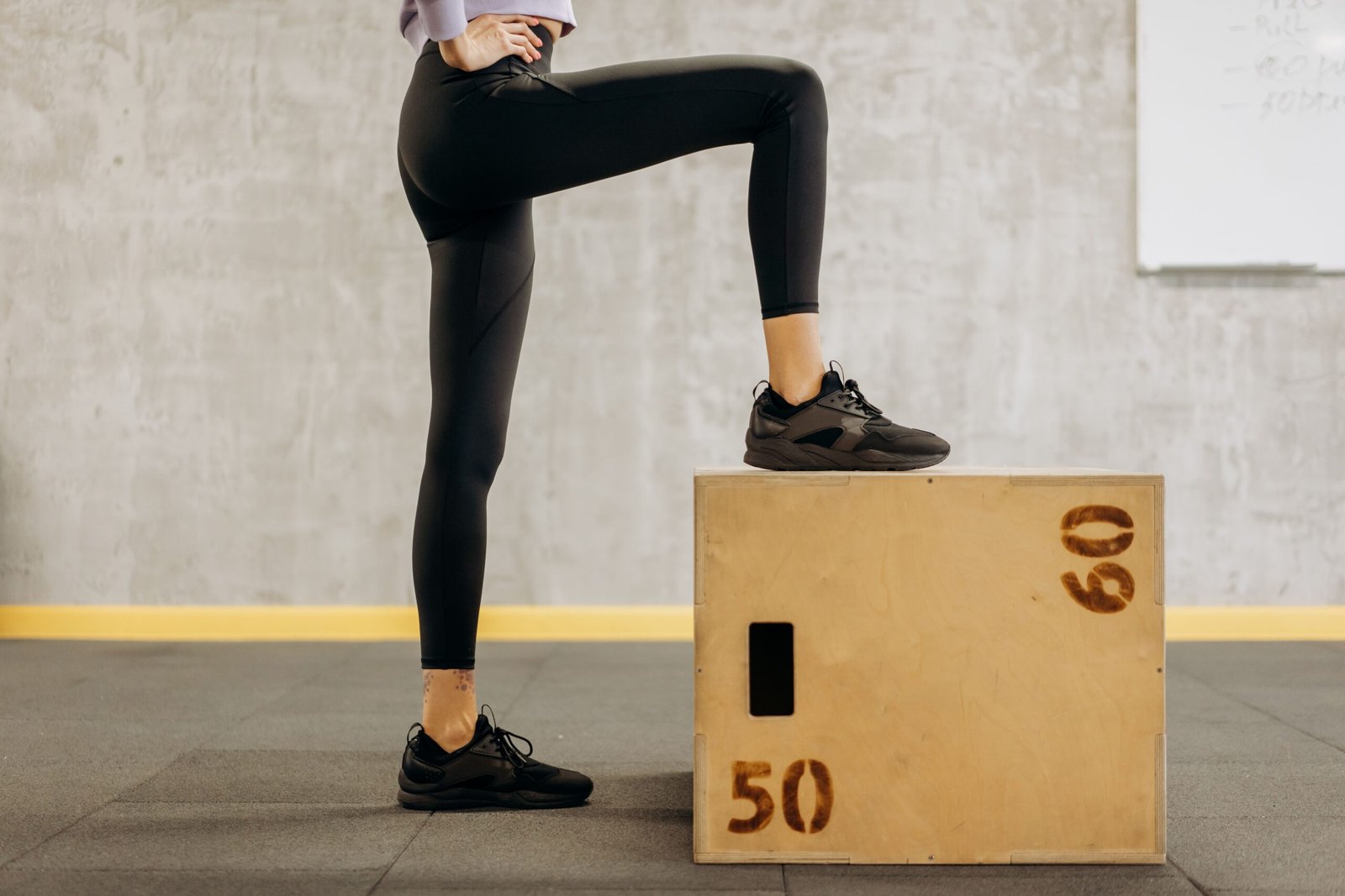 Woman performing a foot and step exercise in a gym