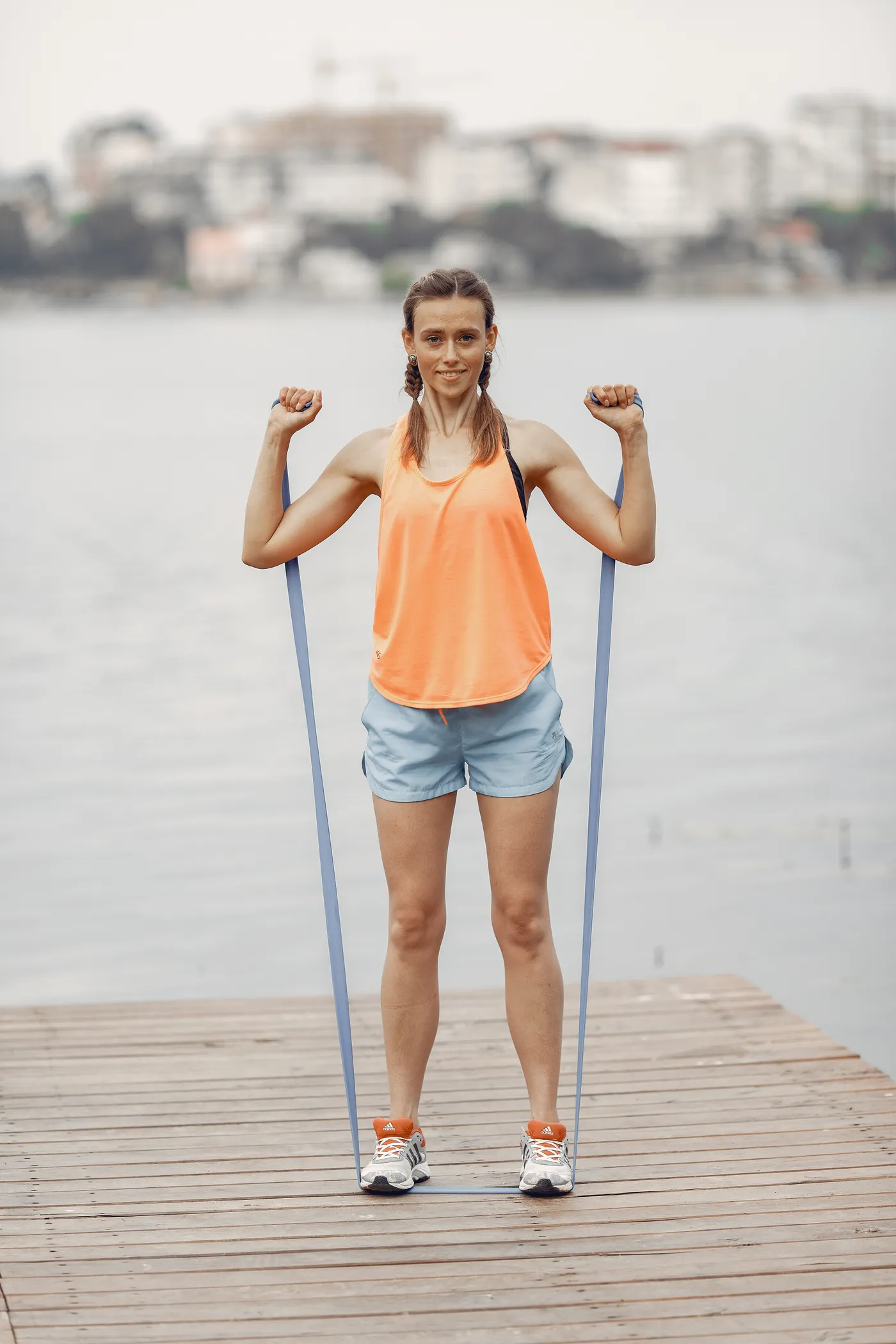 Woman using a resistance band during outdoor exercise