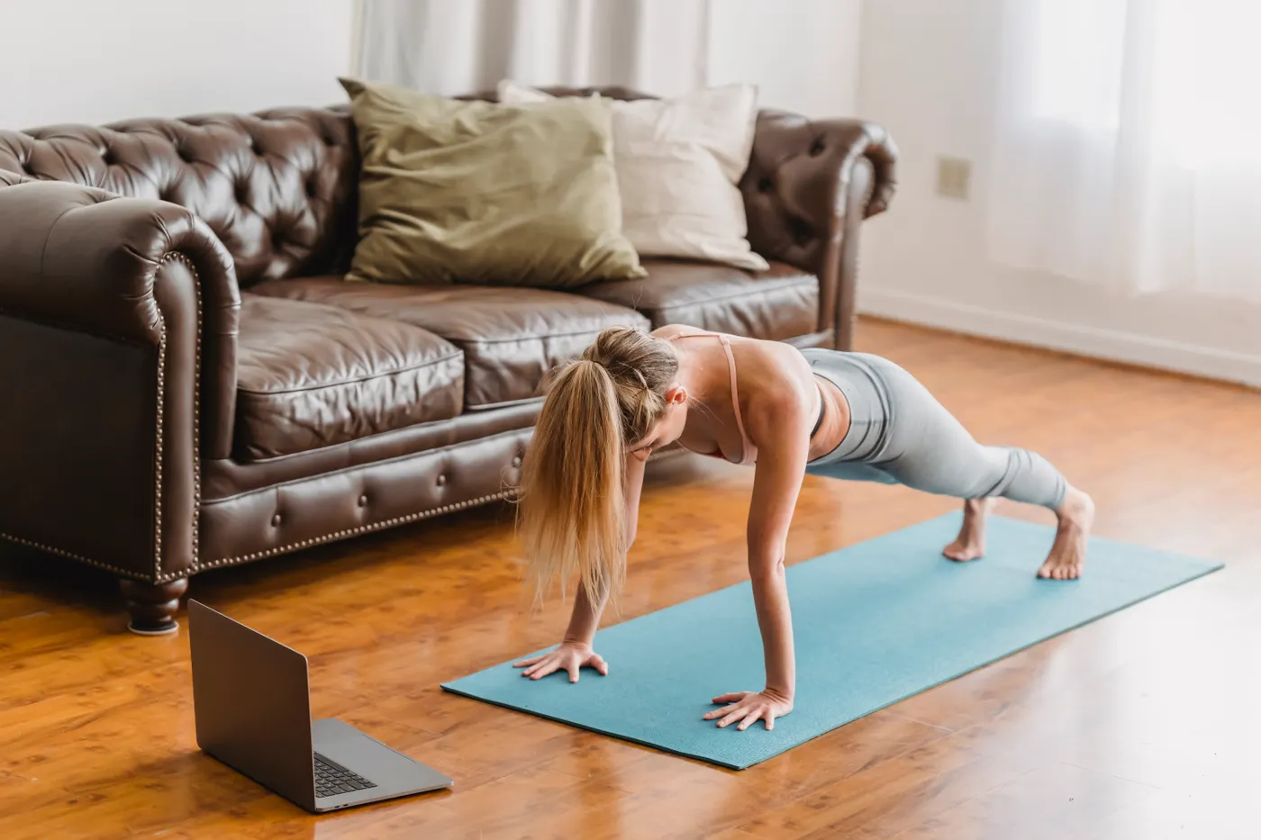 Woman holding a stable plank position during an indoor workout