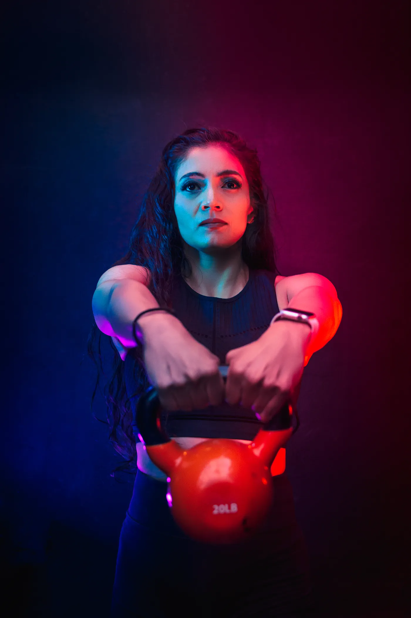Woman holding a red kettlebell during strength training