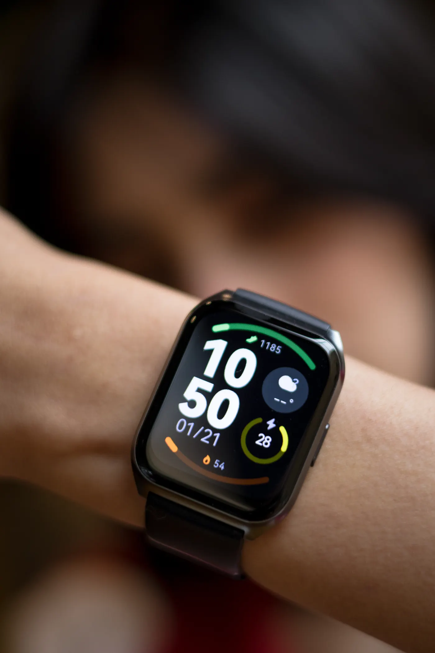 Close-up of a smartwatch displaying fitness data on a wrist
