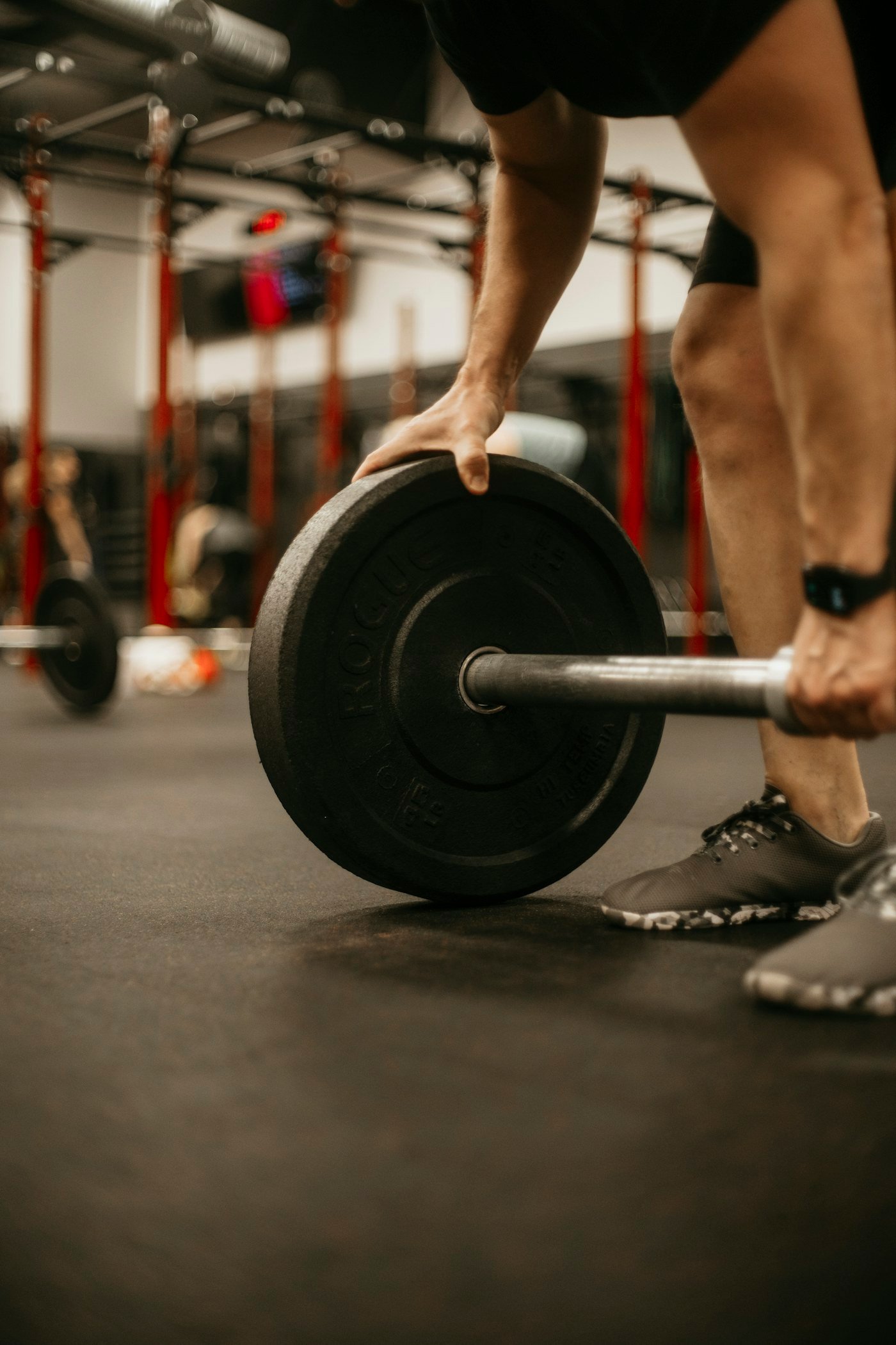 Lifter training with a barbell in a gym