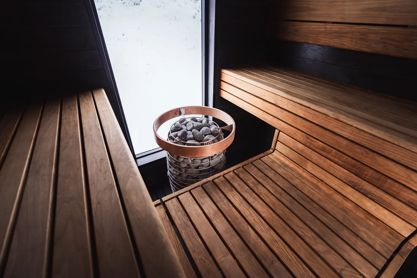 Warm wooden sauna interior with benches and heater