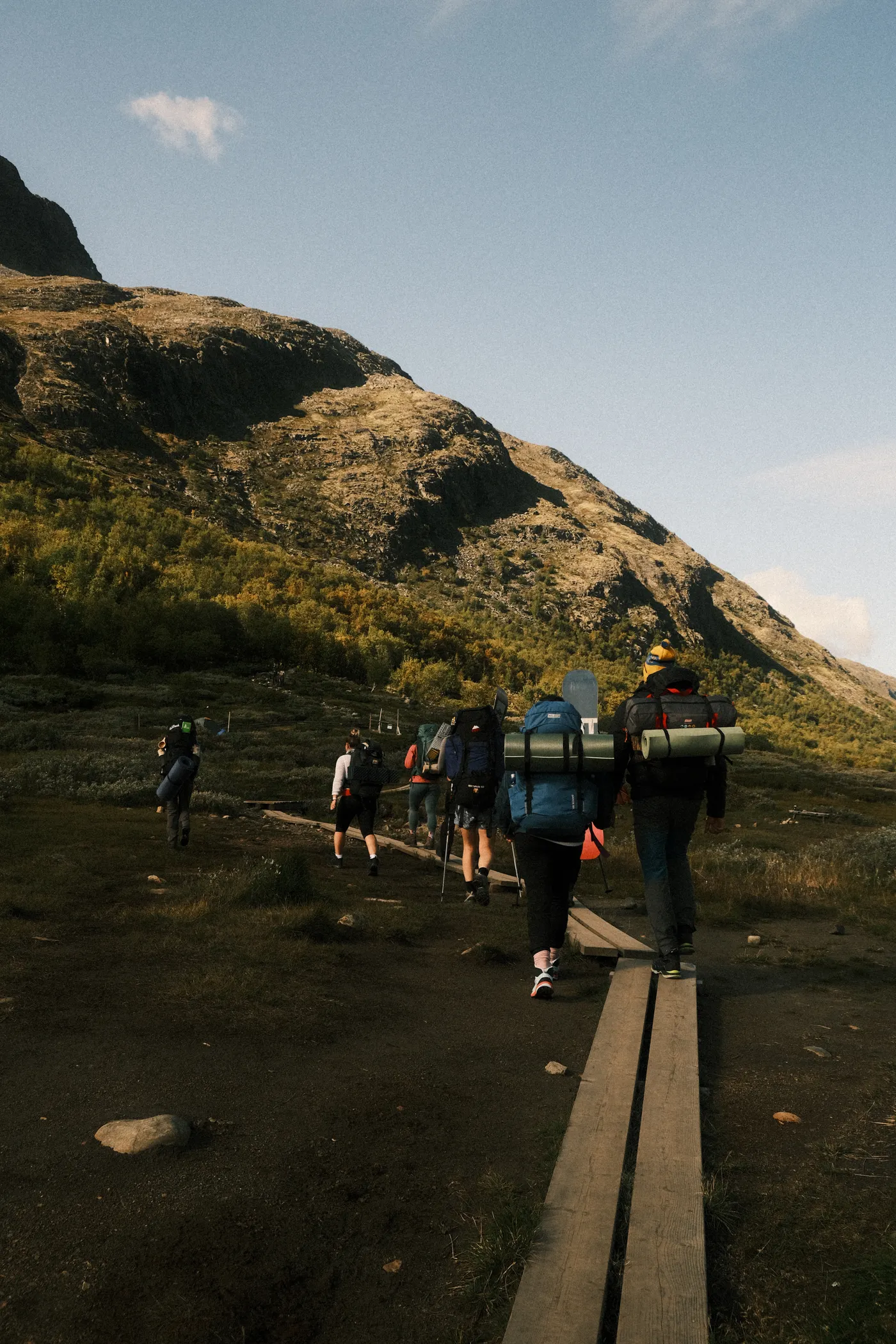 Group of hikers carrying backpacks on a mountain trail
