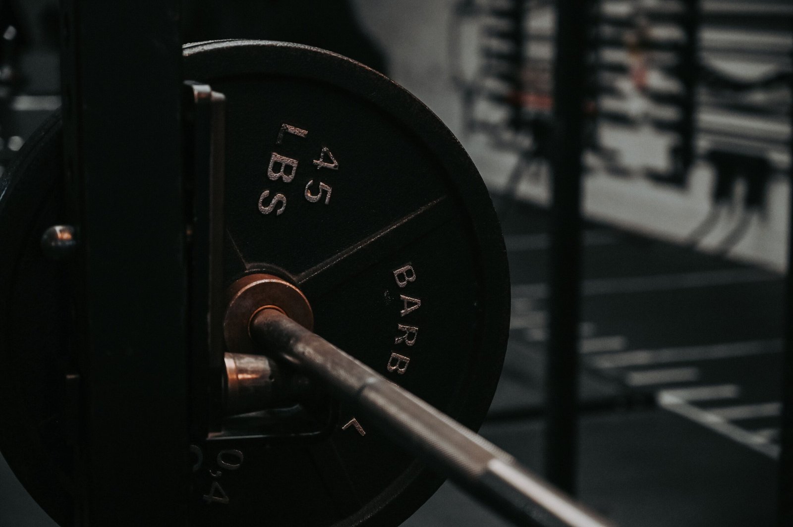 Close-up of a barbell loaded with a 45-pound weight plate