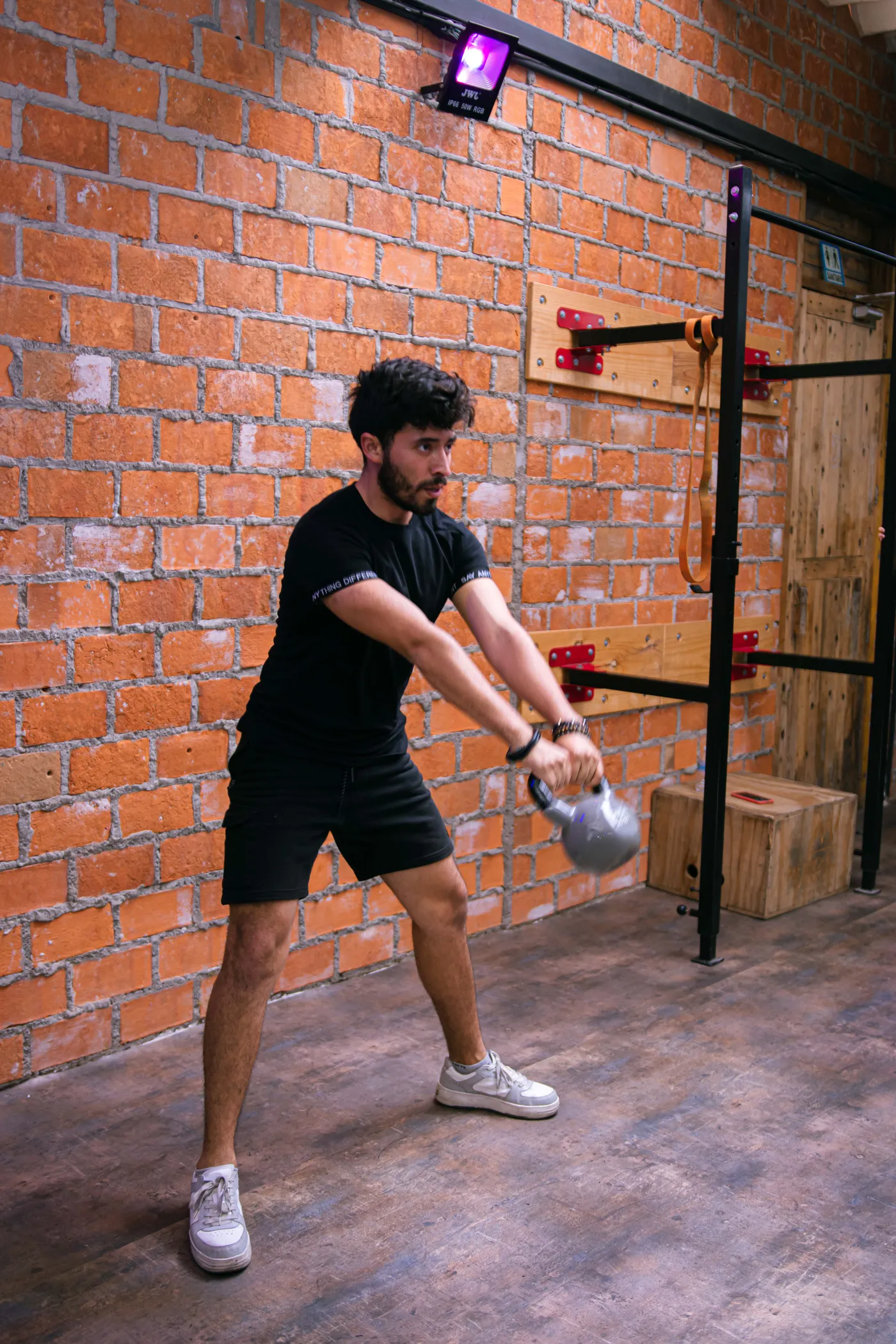 Man lifting a kettlebell during a functional strength workout