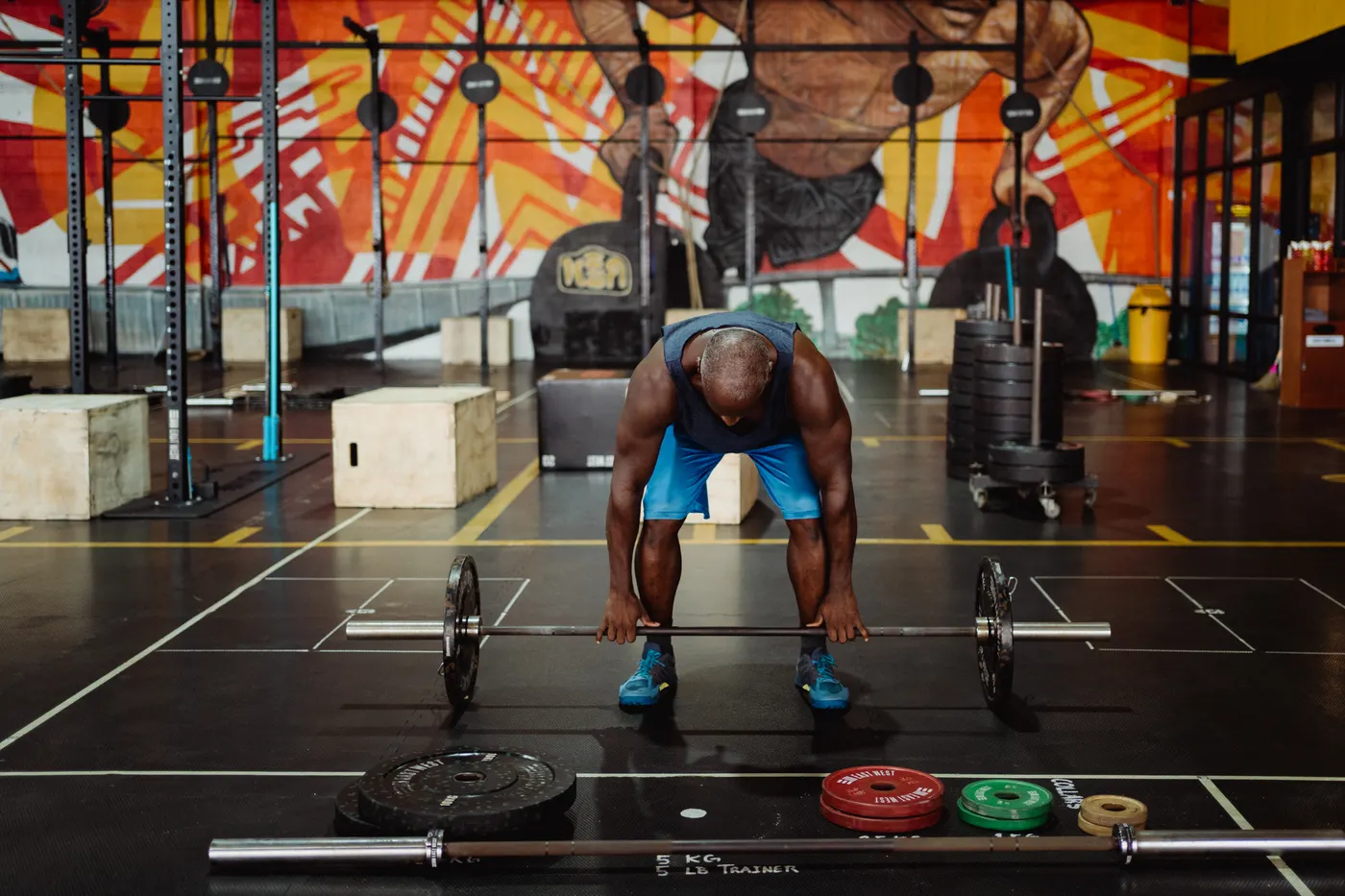 Man performing a barbell lift during a gym workout