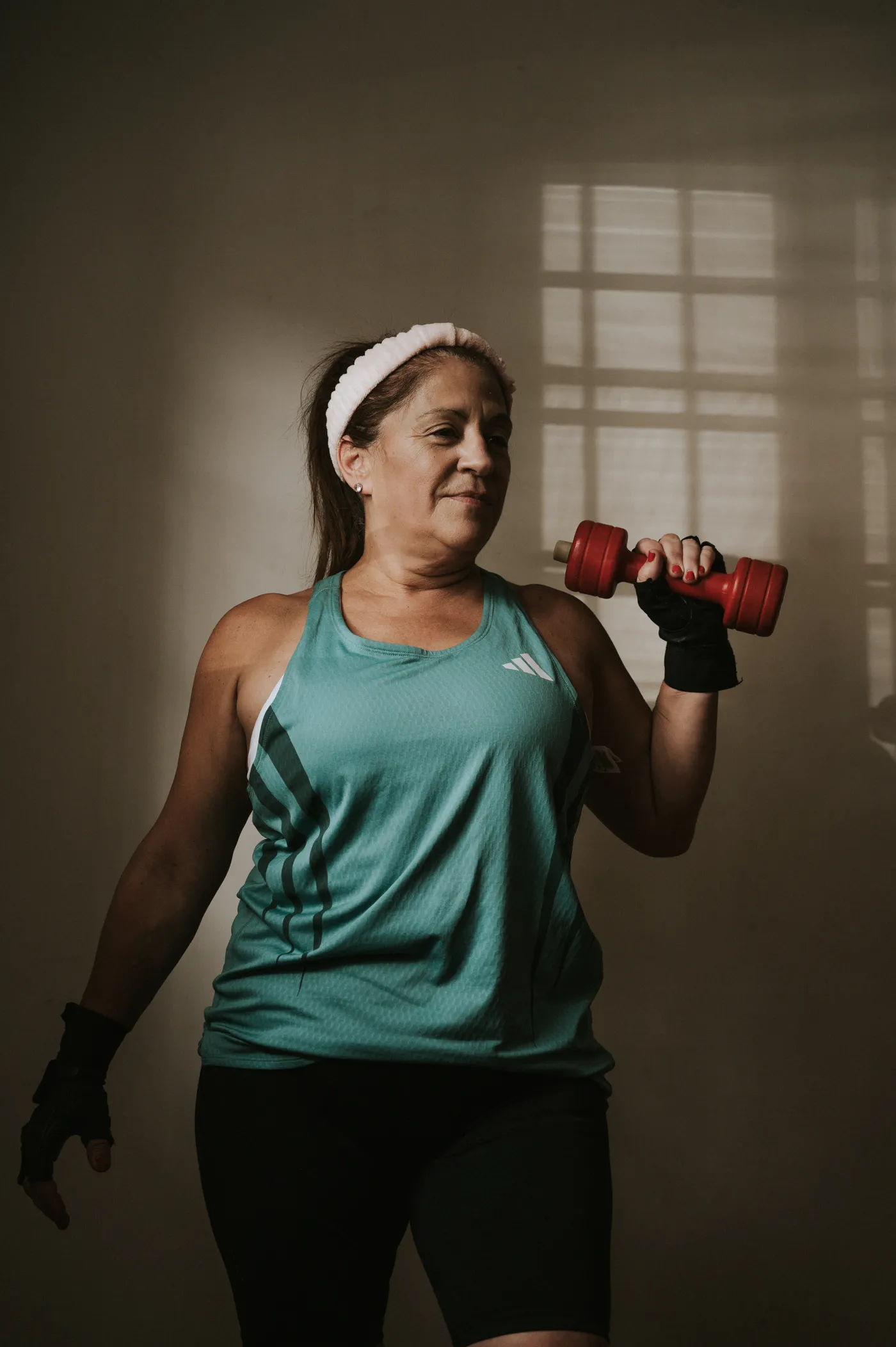 Middle-aged woman performing dumbbell exercise