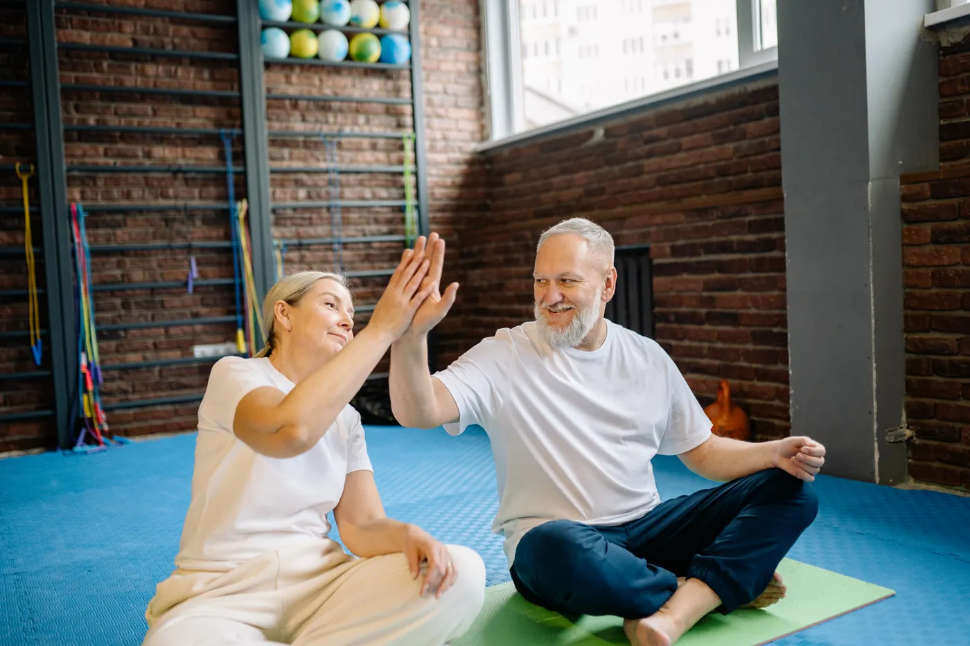 Older adults celebrating a completed fitness session