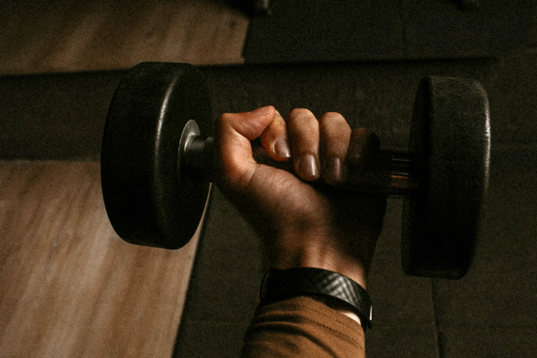 Person lifting a barbell during strength training