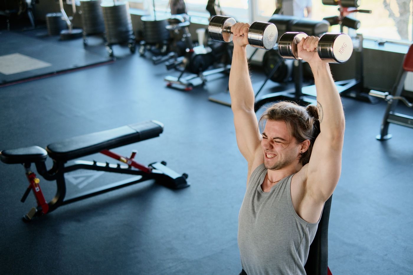 Athlete lifting dumbbells during a focused strength-training session