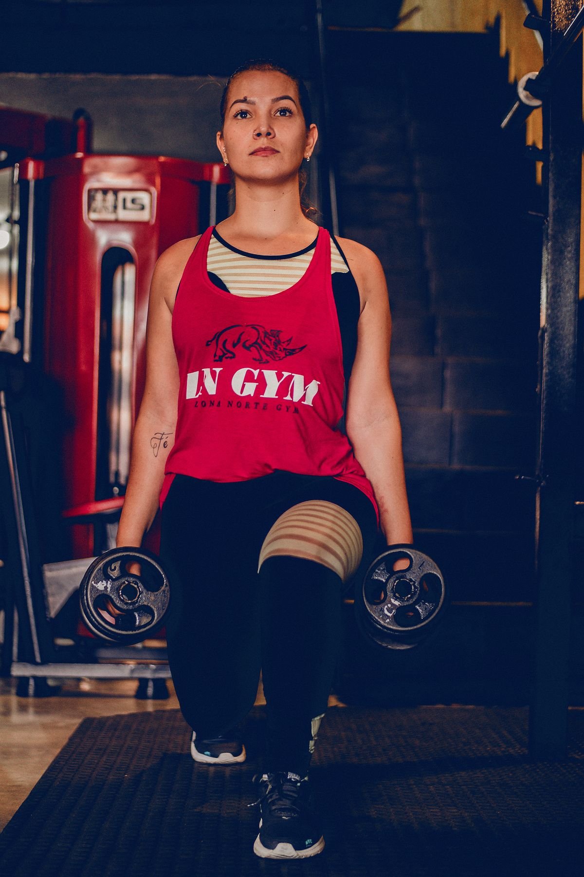 Athlete performing a weighted lunge with dumbbells