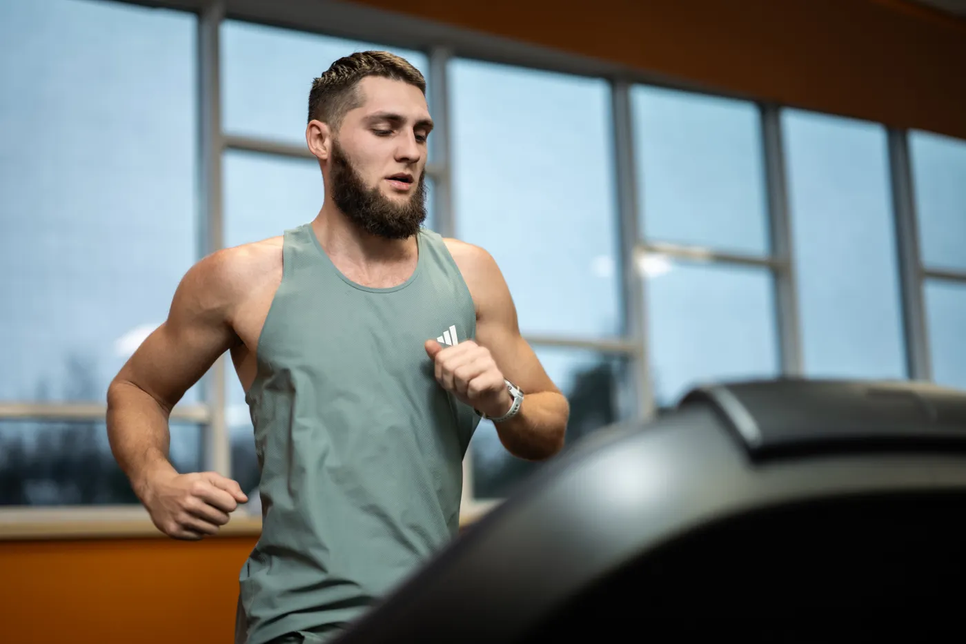 Man running on a treadmill in a gym