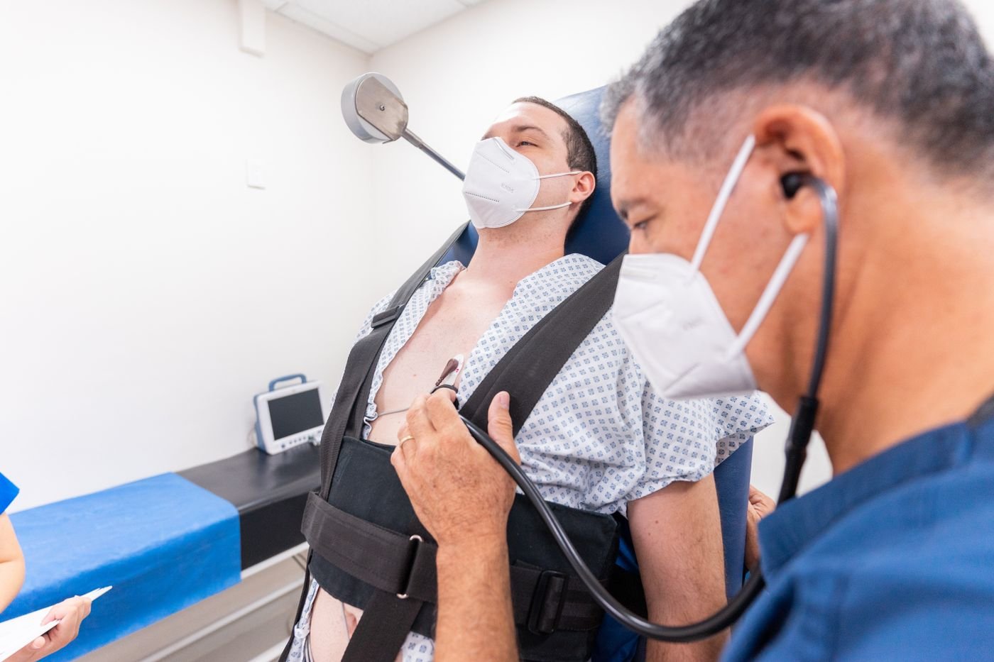 Clinician listening to a patient's chest with a stethoscope