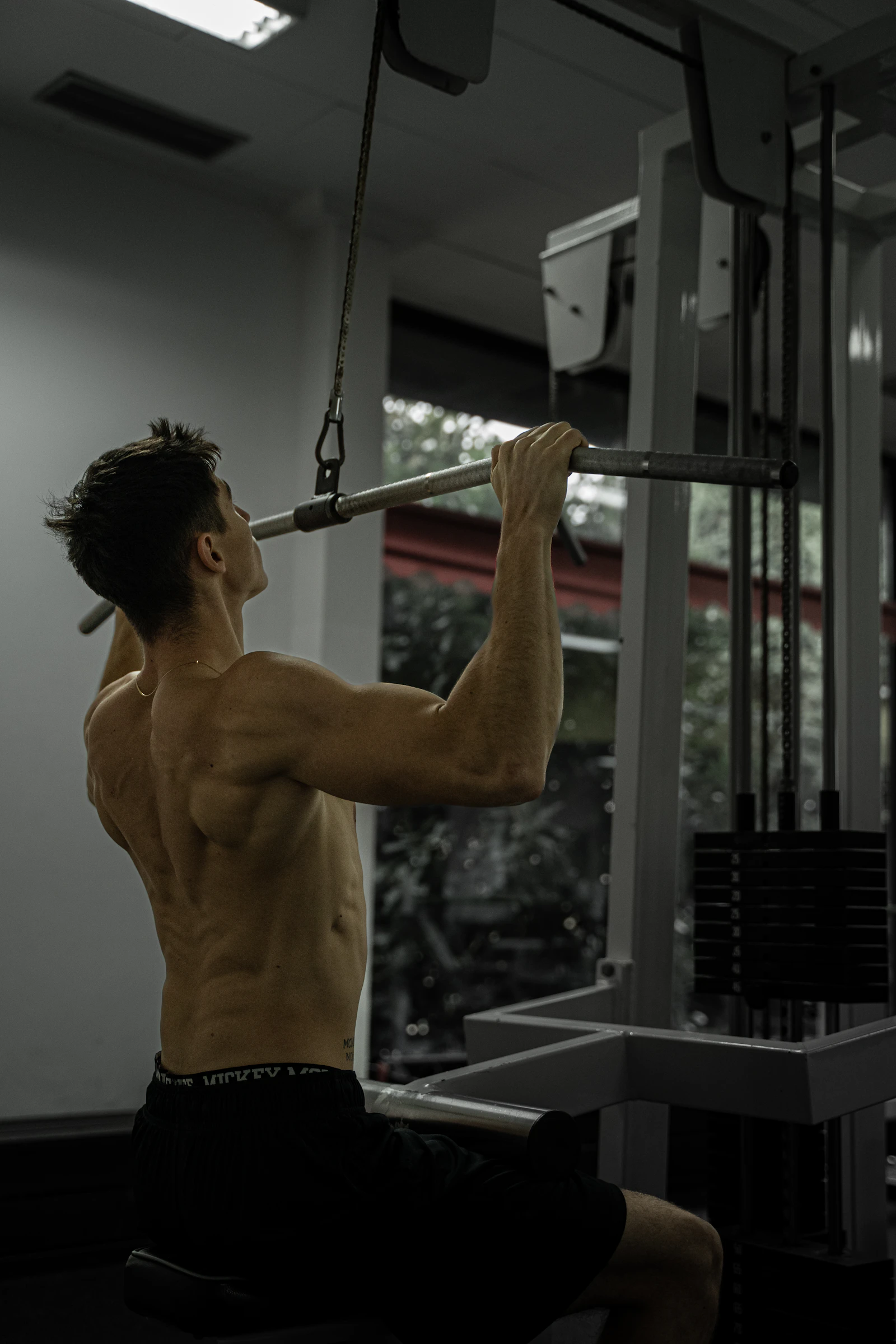 Athlete performing a lat pulldown on a cable machine