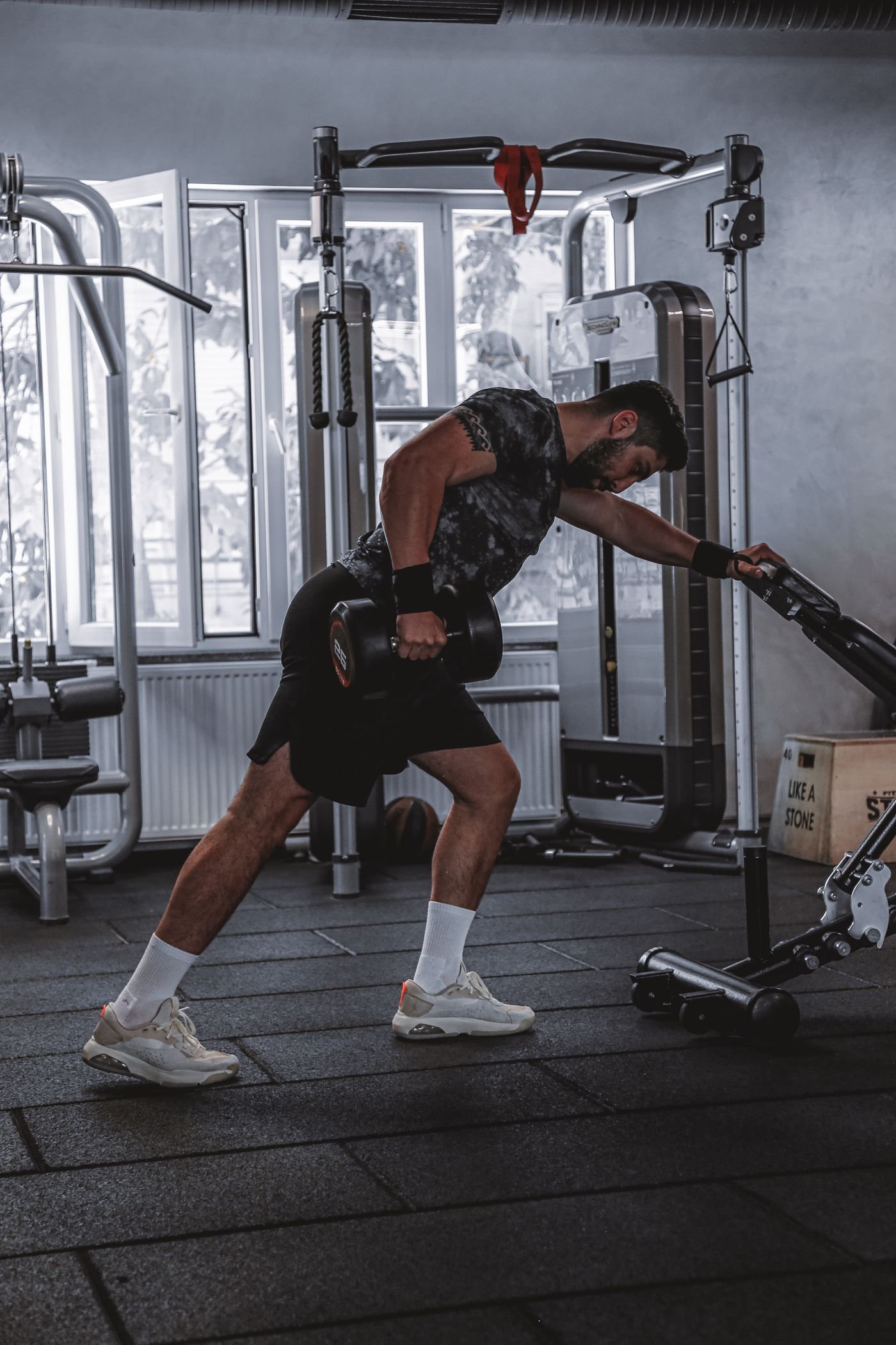 Man performing a dumbbell row during back training