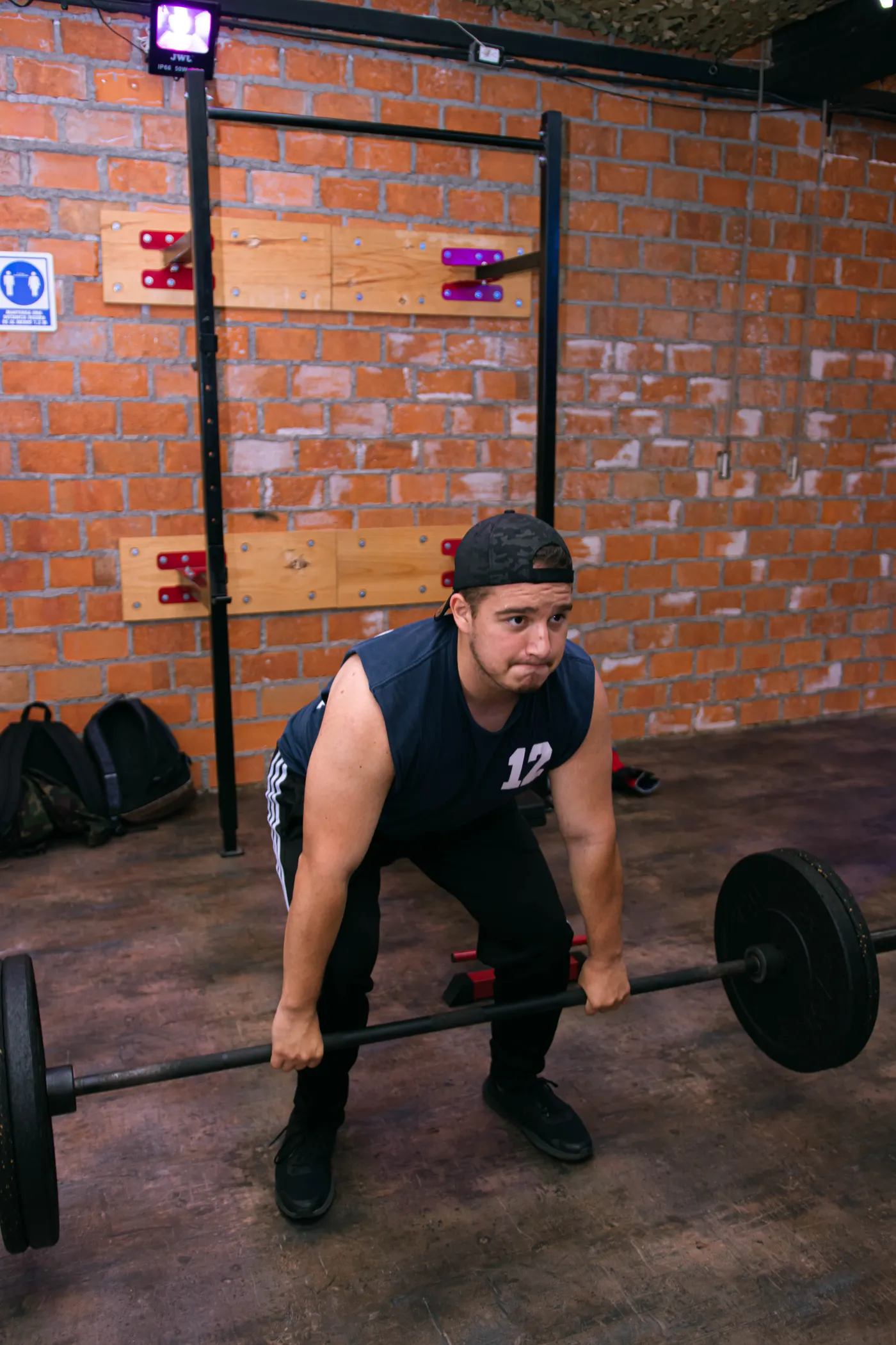 Athlete deadlifting with a straight barbell