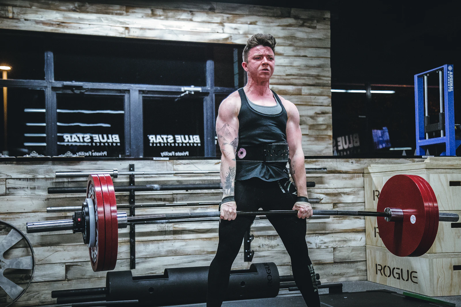 Athlete performing a barbell deadlift in a gym
