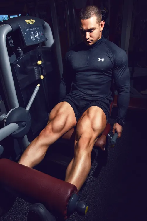 Lifter using a leg-extension machine during lower-body resistance training