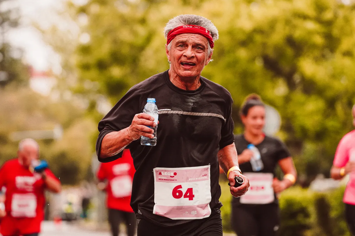 Older distance runner smiling during a marathon