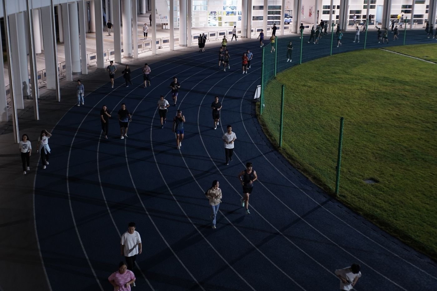 Group of runners on an evening track