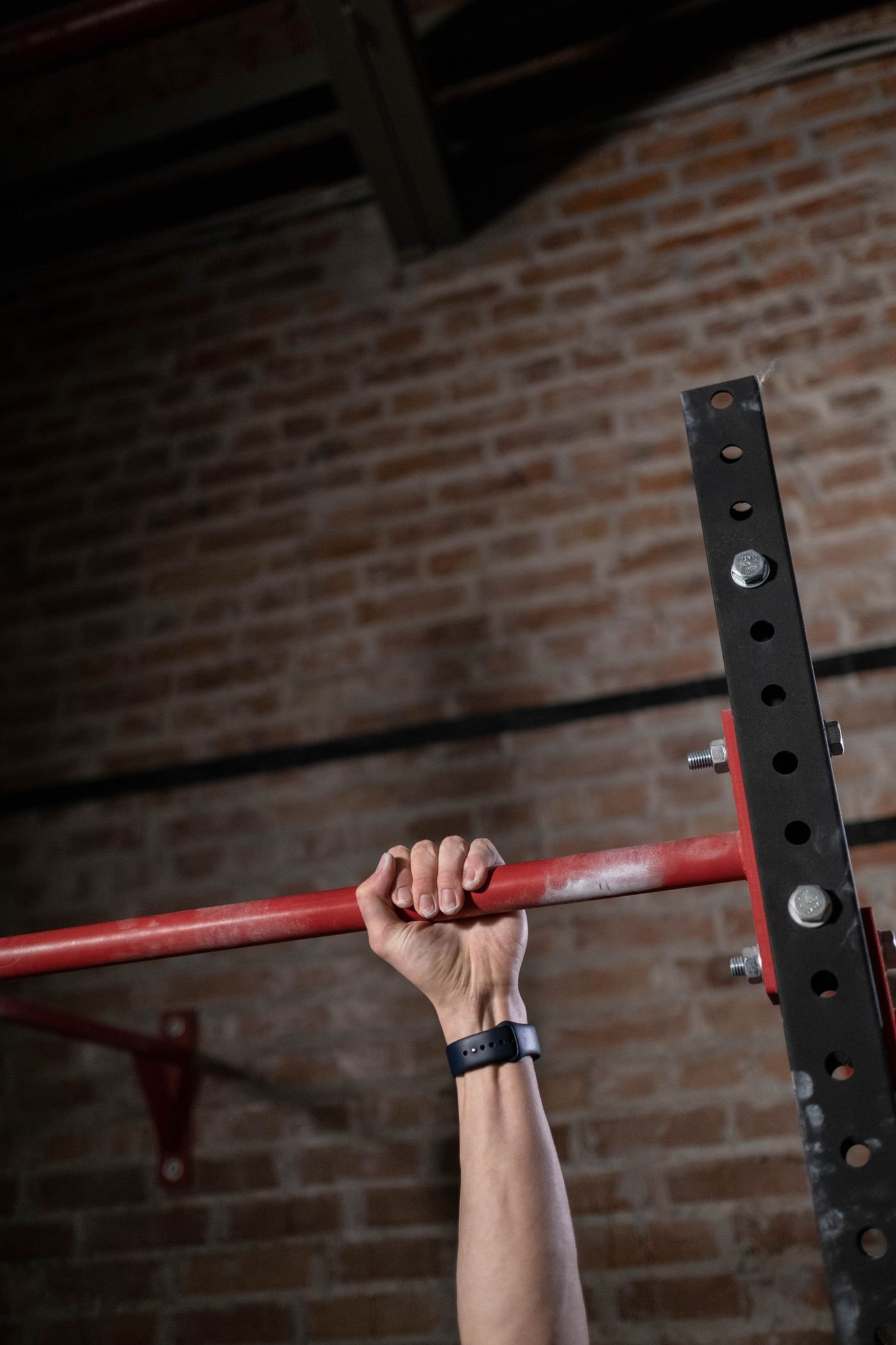 Close-up of a hand holding a pull-up bar
