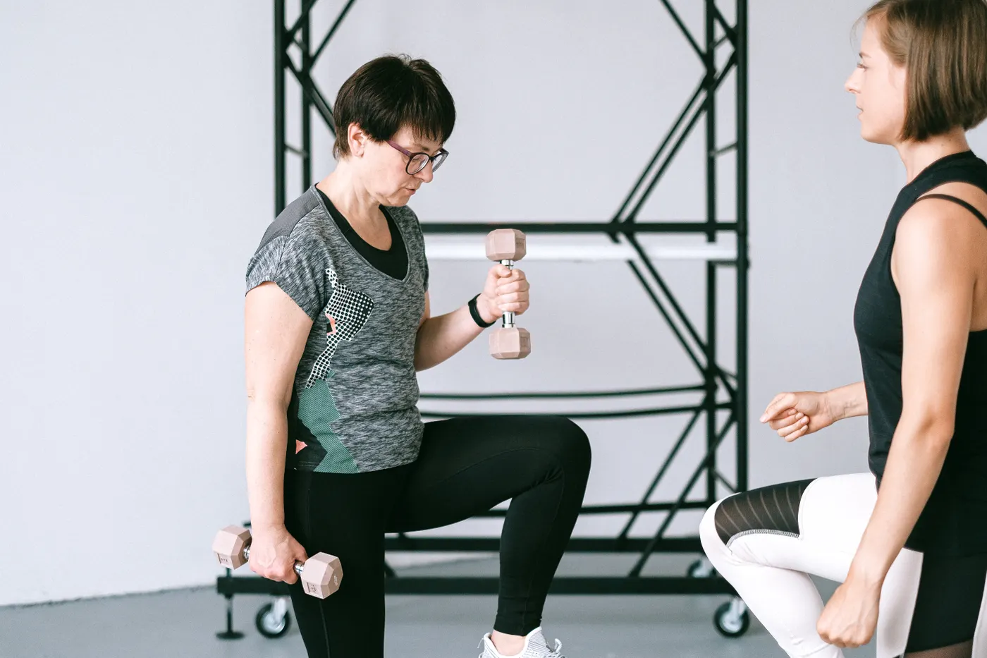 Older woman performing a supervised strength-training exercise