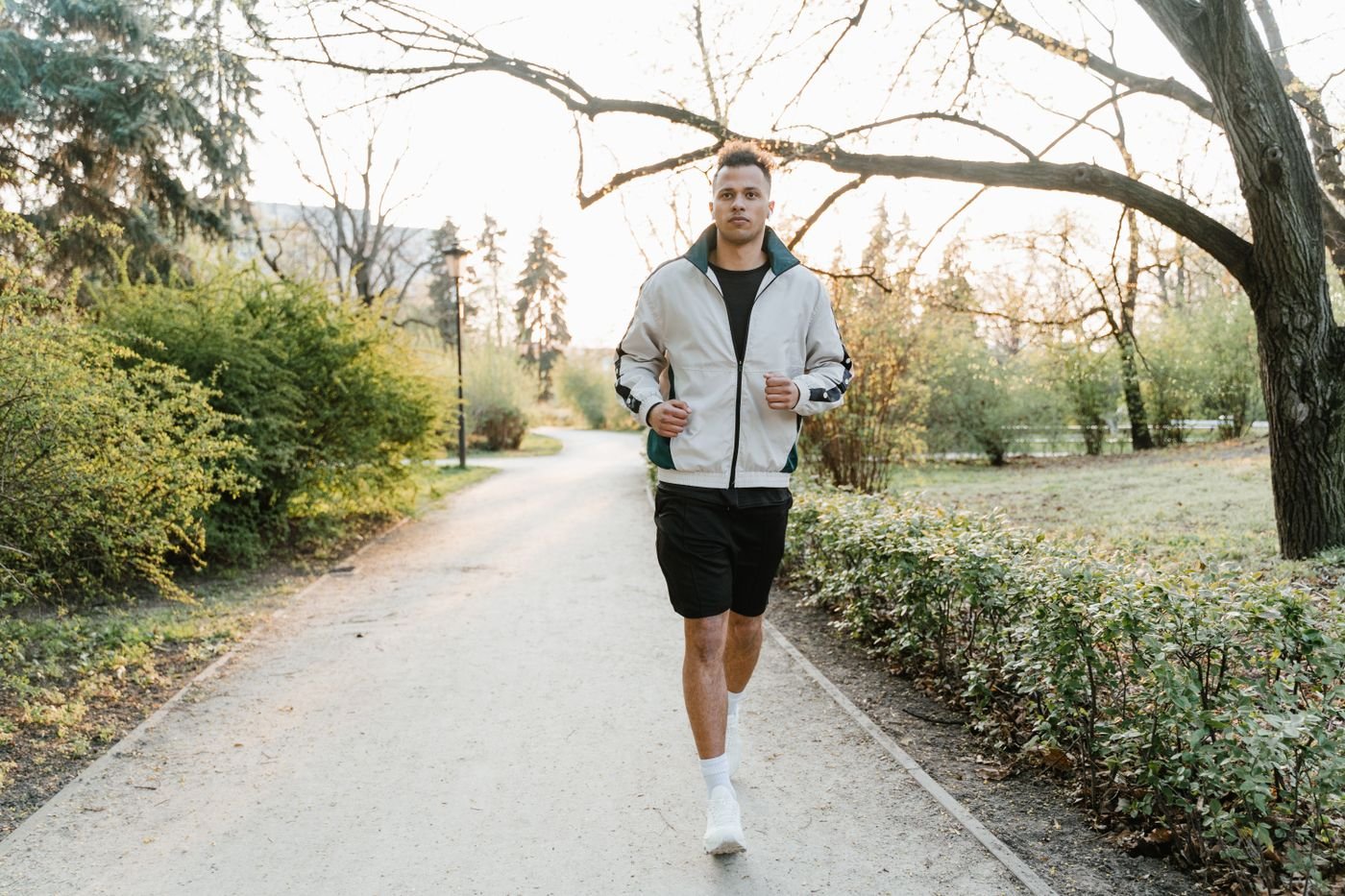 Runner moving along a park path during aerobic exercise