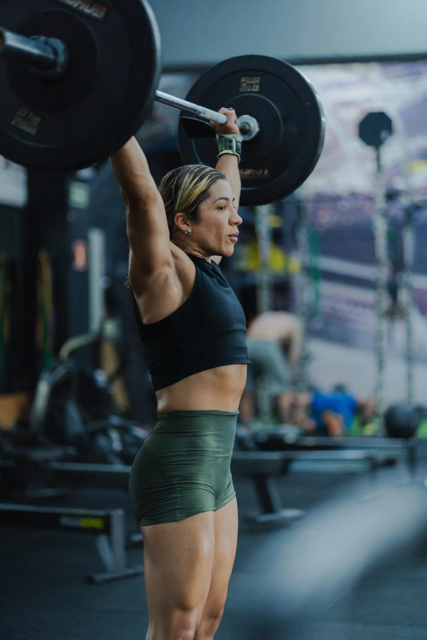 Female athlete performing a barbell strength exercise