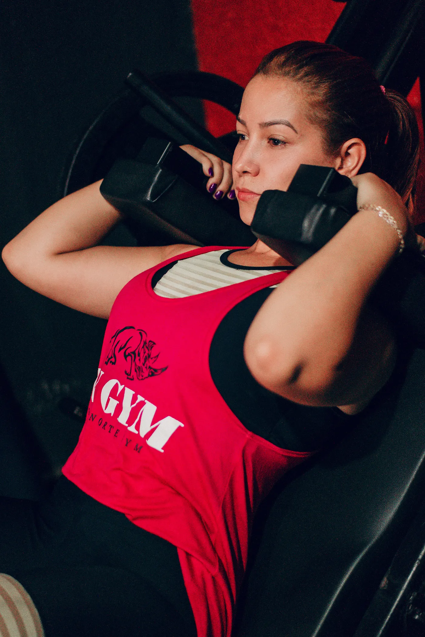 Female athlete lifting a dumbbell in a gym during strength training