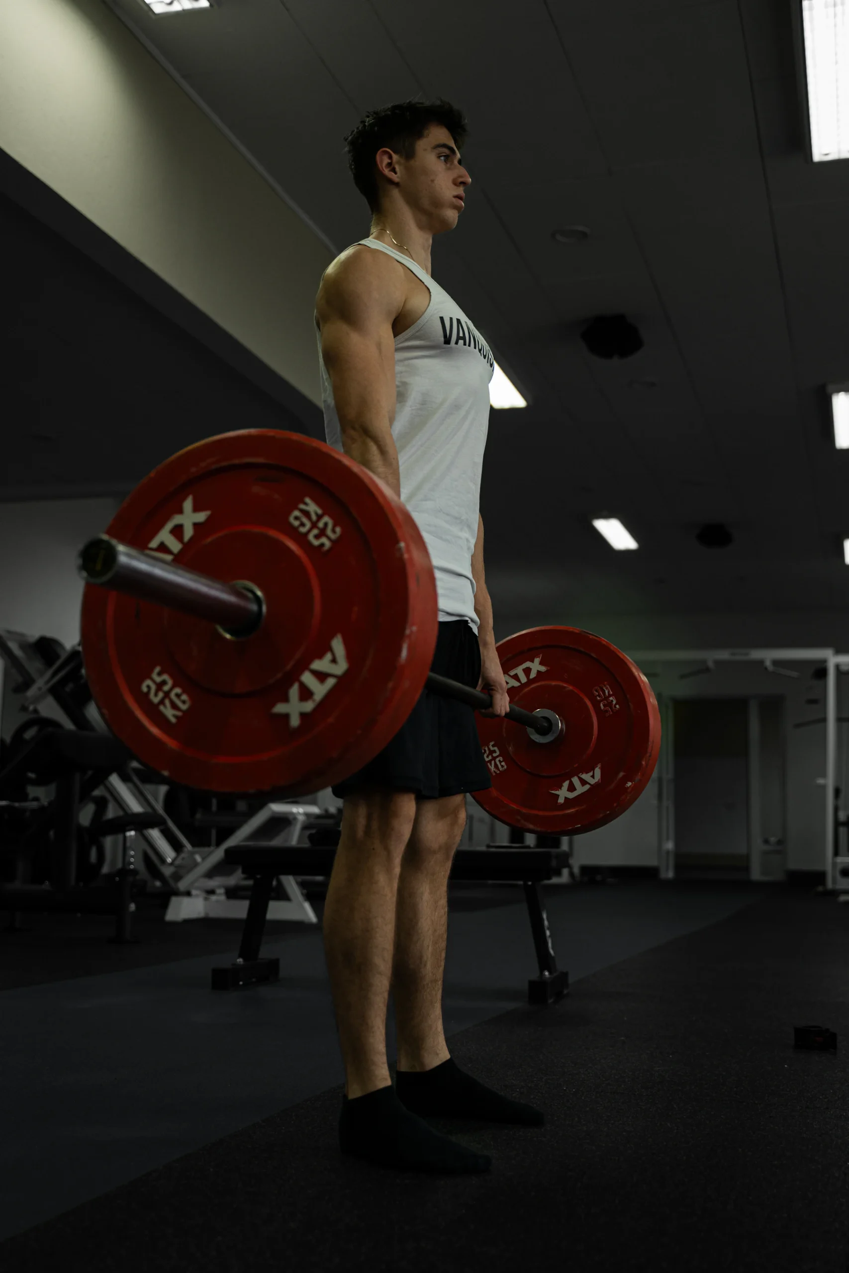 Lifter performing a barbell deadlift in a gym