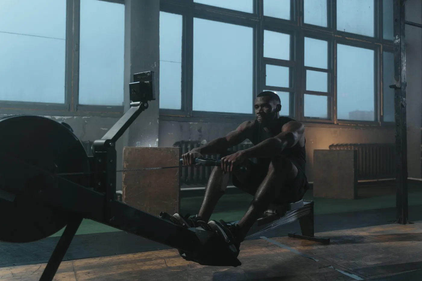 Man performing a rowing machine workout in the gym