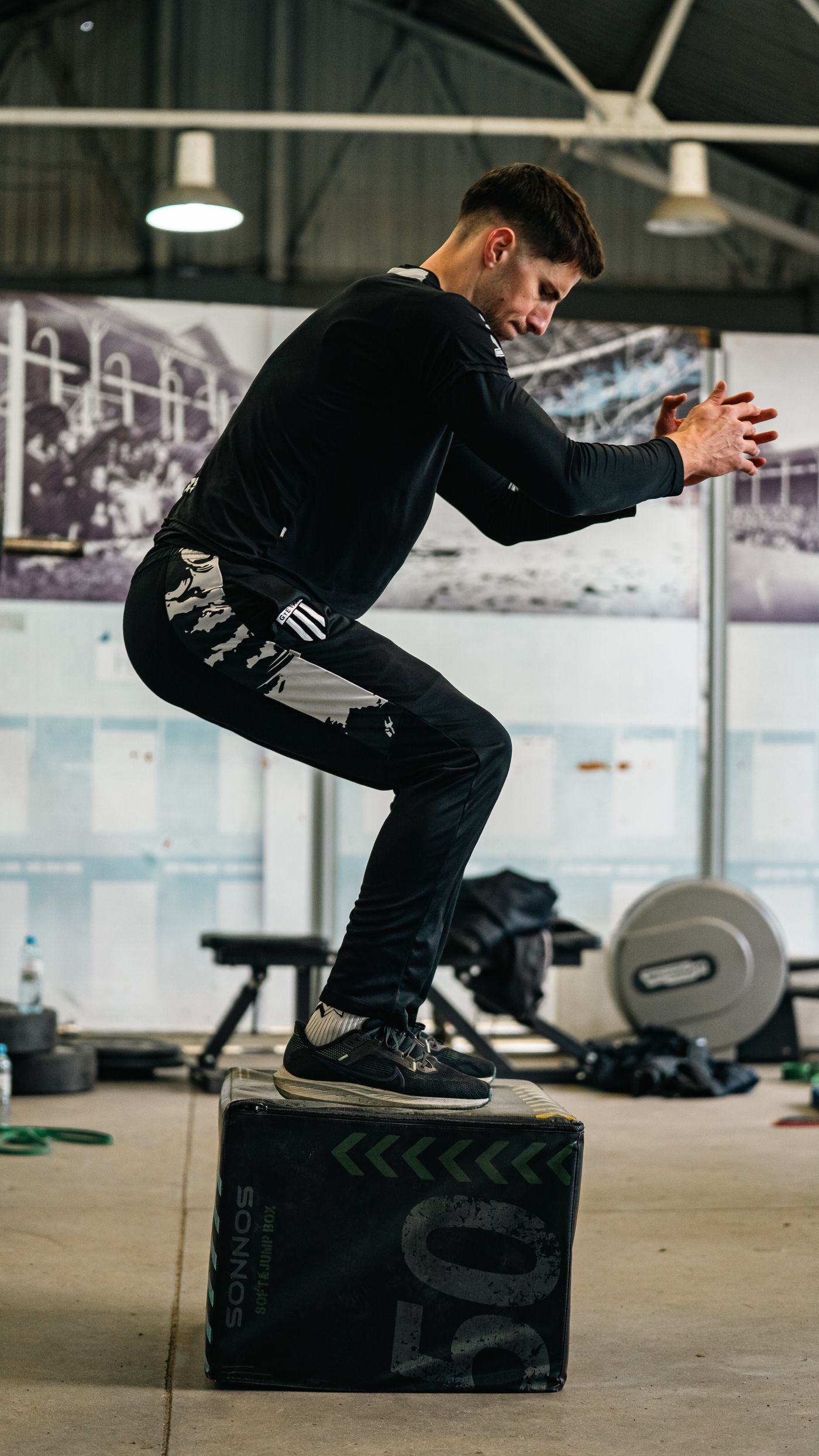 Athlete performing a box jump during gym training