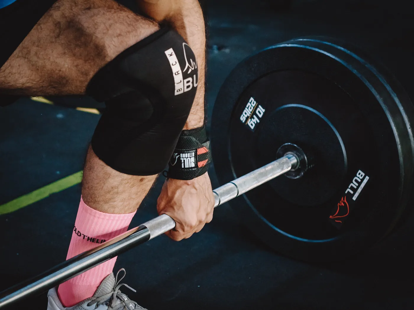 Athlete gripping a barbell during a strength workout