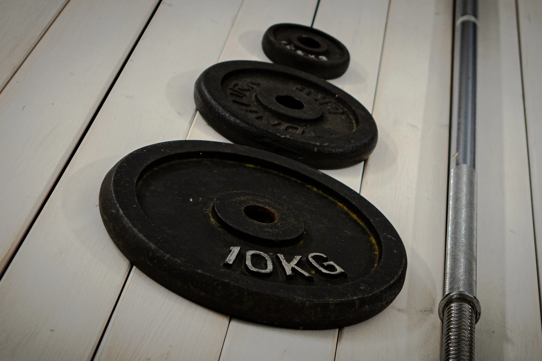 Close-up of weight plates and barbell for strength training